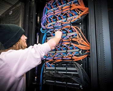 a computing student fixing network cabling 