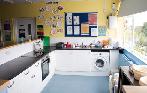 Picture of classroom kitchen with pin-boards on walls with posters and information.