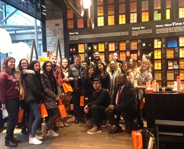 Large group photo of students smiling in T2Tea shop
