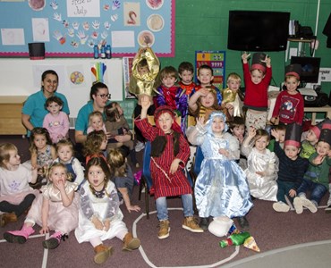 Group photo of nursery children in a classroom and dressed up for their nativity play.