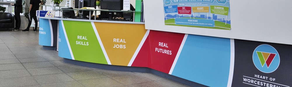 A close up of the branded reception desk at Heart of Worcestershire College All Saints' Building