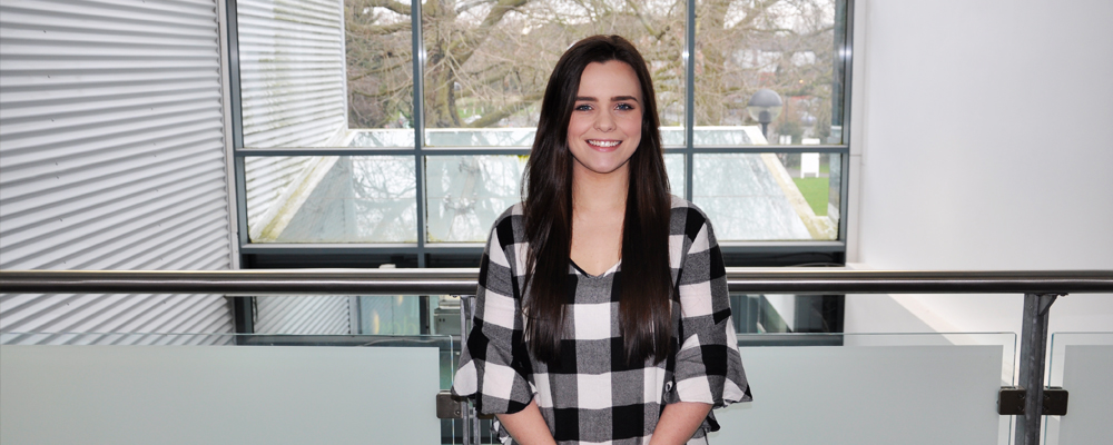 Female student stood in front of window