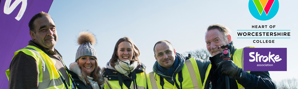 Group of 5 males and females in high visibility jackets. Stroke association and college logo also displayed.