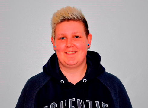 Close up image of female smiling and wearing a dark hoodie