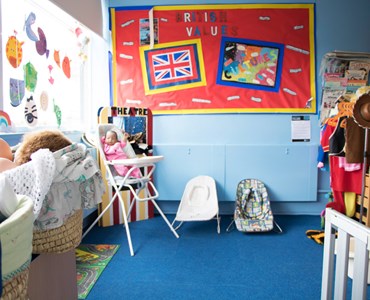 Health and social care classroom with children's toys, seats and colourful noticeboard