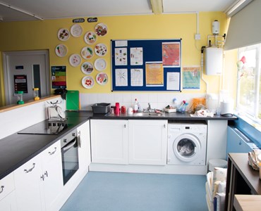 Health and social care kitchen classroom with noticeboards.