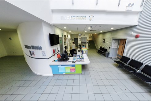 Image of reception area; main desk, lift and seating can be seen.