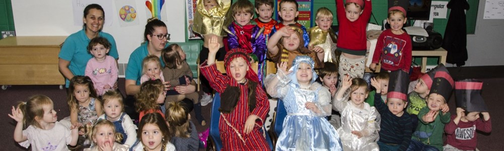Group photo of nursery children in a classroom and dressed up for their nativity play.