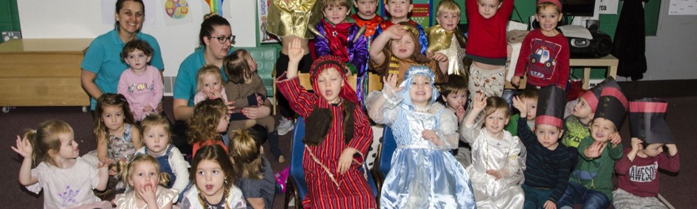 Group photo of nursery children in a classroom and dressed up for their nativity play.