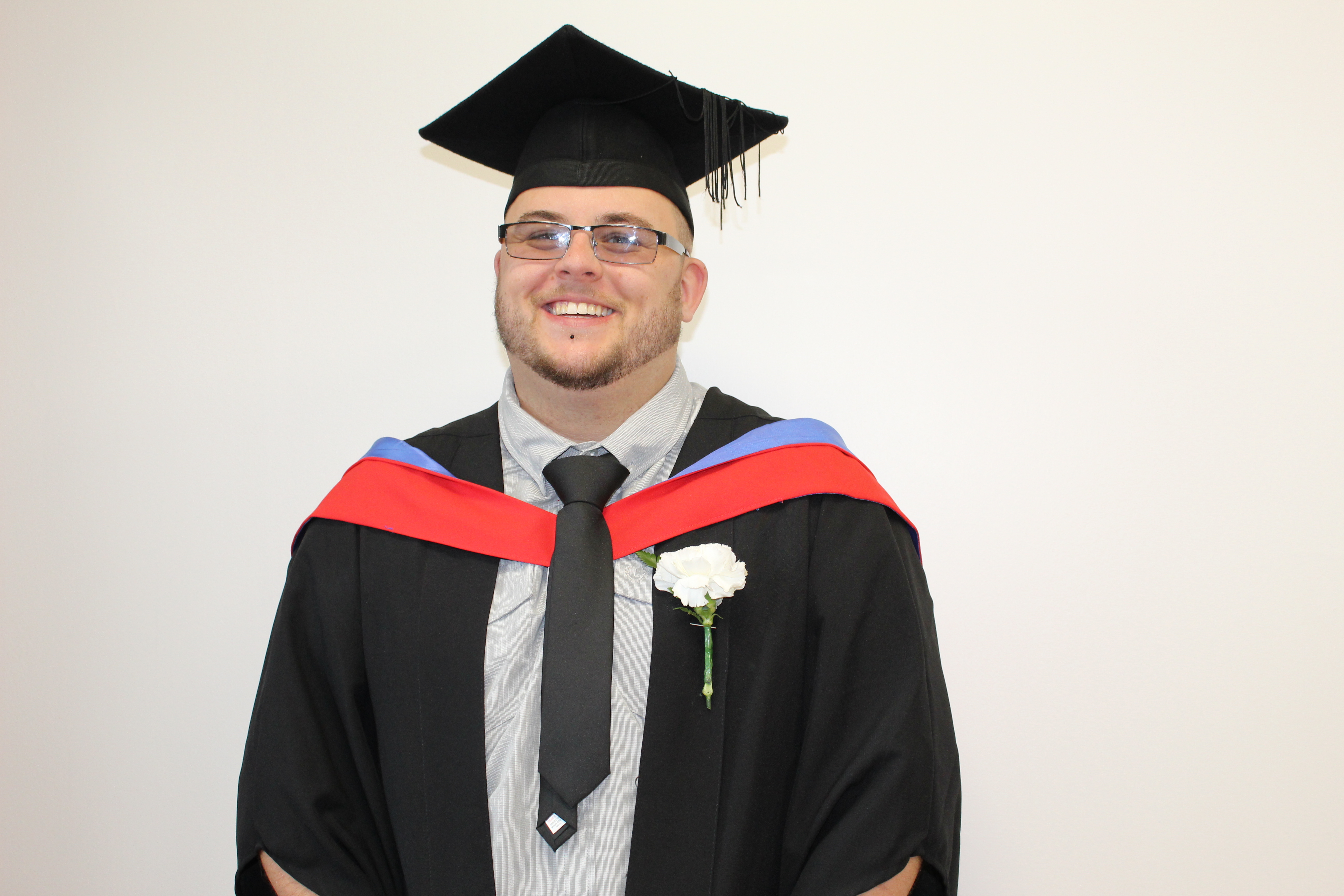 Male student in graduation cap and gown