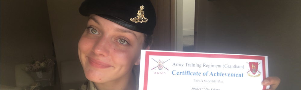 Image of a smiling, female student in Army uniform holding a certificate.
