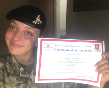 Image of a smiling, female student in Army uniform holding a certificate.