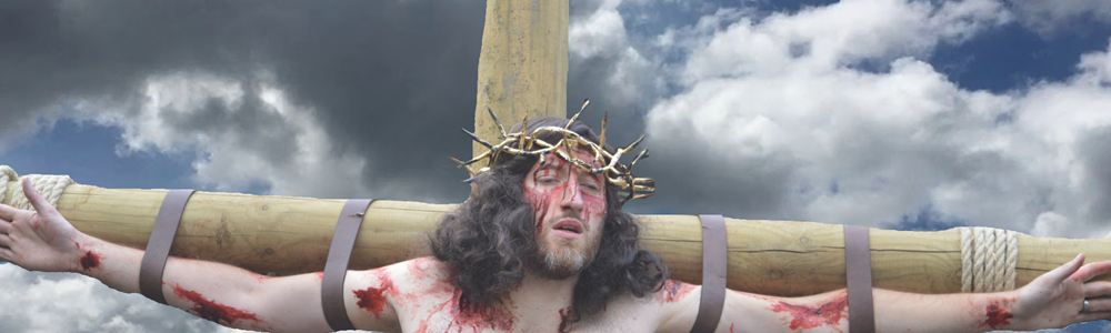 Actor portraying Jesus is strapped to a wooden cross in relation to an upcoming performance of Wintershall Passion Play