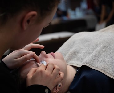 Lash Technician applying lashes to a client 