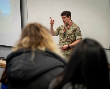 Army officer talking to students
