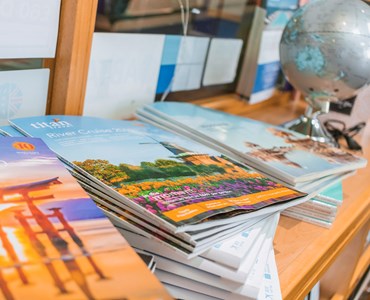 a pile of numerous travel and tourism books