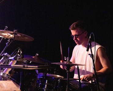 A male student playing the drums