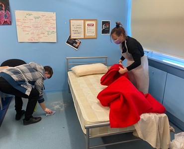 Health and social care students completing simulation for infection prevention