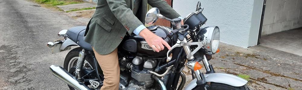 Man dressed dapper on a motorcycle