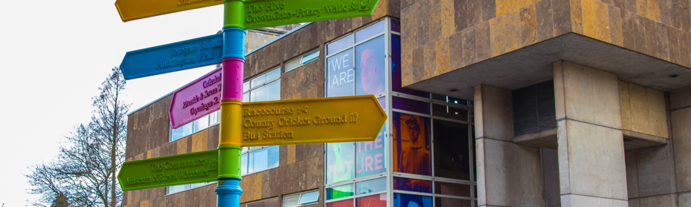 Fingerpost sign designed by HoW College art students placed outside All Saints building