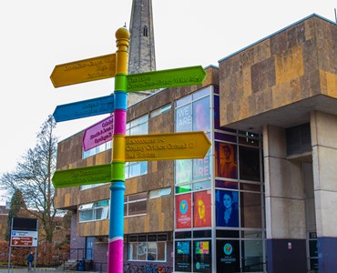 Fingerpost sign designed by HoW College art students placed outside All Saints building