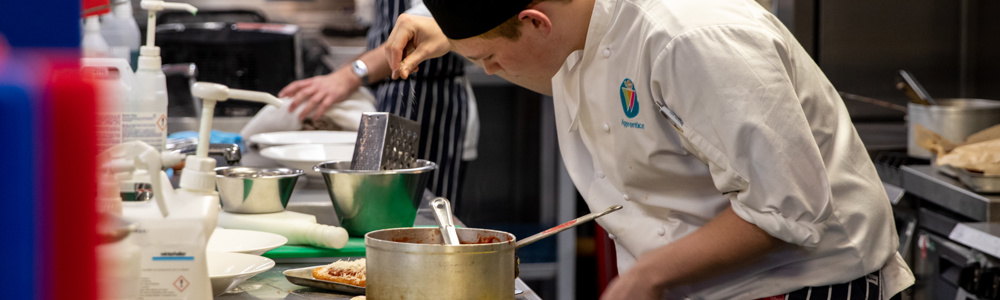 HoW College Catering student cooking in kitchen