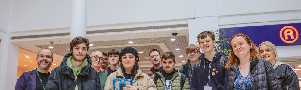 Heart of Worcestershire College Creative Media students gather in a group below Paolozzi's mosaics as Kingfisher Shopping Centre, Redditch 