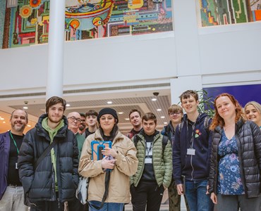 Heart of Worcestershire College Creative Media students gather in a group below Paolozzi's mosaics as Kingfisher Shopping Centre, Redditch 