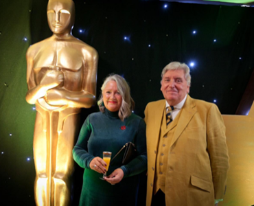 Ann Isherwood and Husband at Redditch Business Awards smiling for a photo