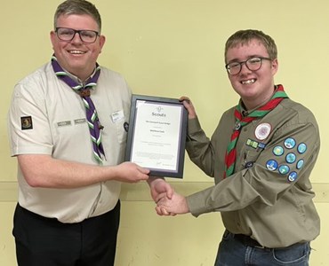 HoW College student , Matt, shaking hands with Leader of Scouts for Warwickshire